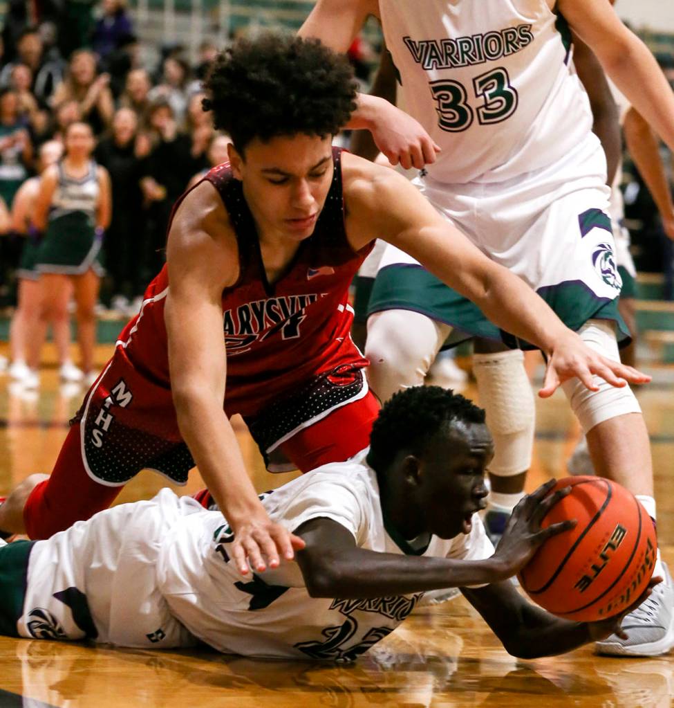 Edmonds-Woodways Mutdung Bol (bottom) struggles for a loose ball with Marysville Pilchucks Ethan Jackson reaching in during a game on Dec. 14, 2018, at Edmonds-Woodway High School. (Kevin Clark / Herald file)