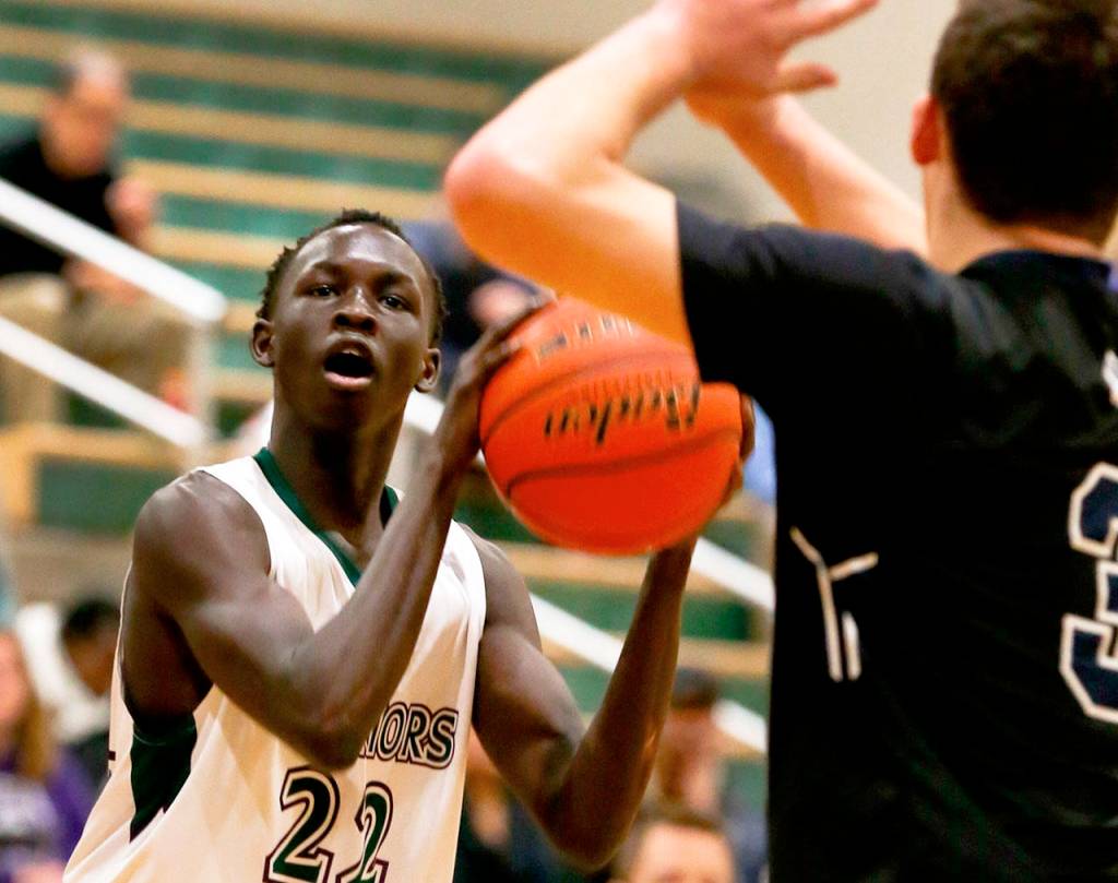Edmonds-Woodways Mutdung Bol (left) attempts a shot during a game against Arlington on Jan. 9, 2019, at Edmonds-Woodway High School. (Kevin Clark / Herald file)