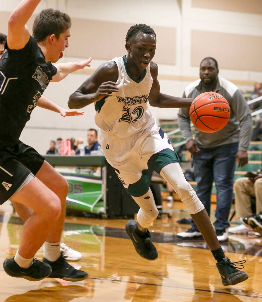 Edmonds-Woodways Mutdung Bol (right) controls the ball with Arlingtons Griffin Gardoski defending during a game on Jan. 9, 2019, at Edmonds-Woodway High School. (Kevin Clark / Herald file)