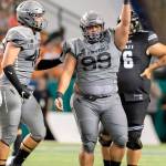 Air Force defensive lineman Mosese Fifita (99), a Glacier Peak alum, holds up the football to celebrate recovering a fumble during a game against Hawaii on Oct. 19, 2019, in Honolulu. (AP Photo/Eugene Tanner)