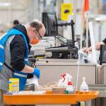 A team cleans shared work stations at the Boeing factory in Renton as defense-related operations restarted last week. (Boeing)