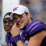 Washington quarterback Jacob Eason, a Lake Stevens alum, smiles on the sideline during a game against Eastern Washington on Aug. 31, 2019, in Seattle. (AP Photo/Elaine Thompson)