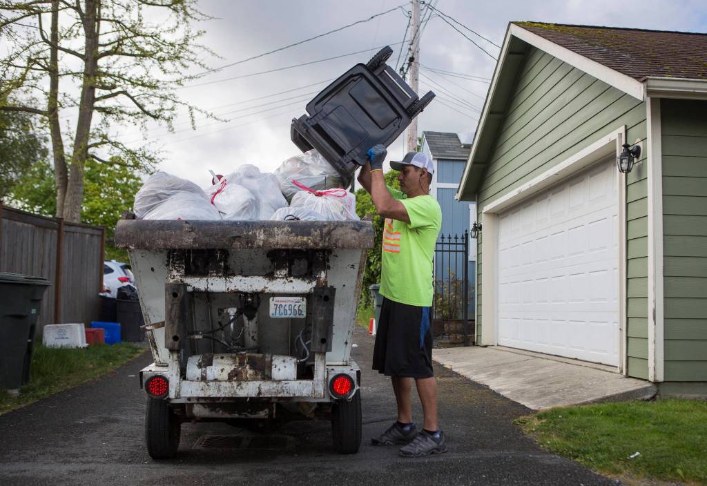 Essential worker Tony Ubhi, a Rubatino garbage man for seven years, at work in Everett. (Olivia Vanni / The Herald)