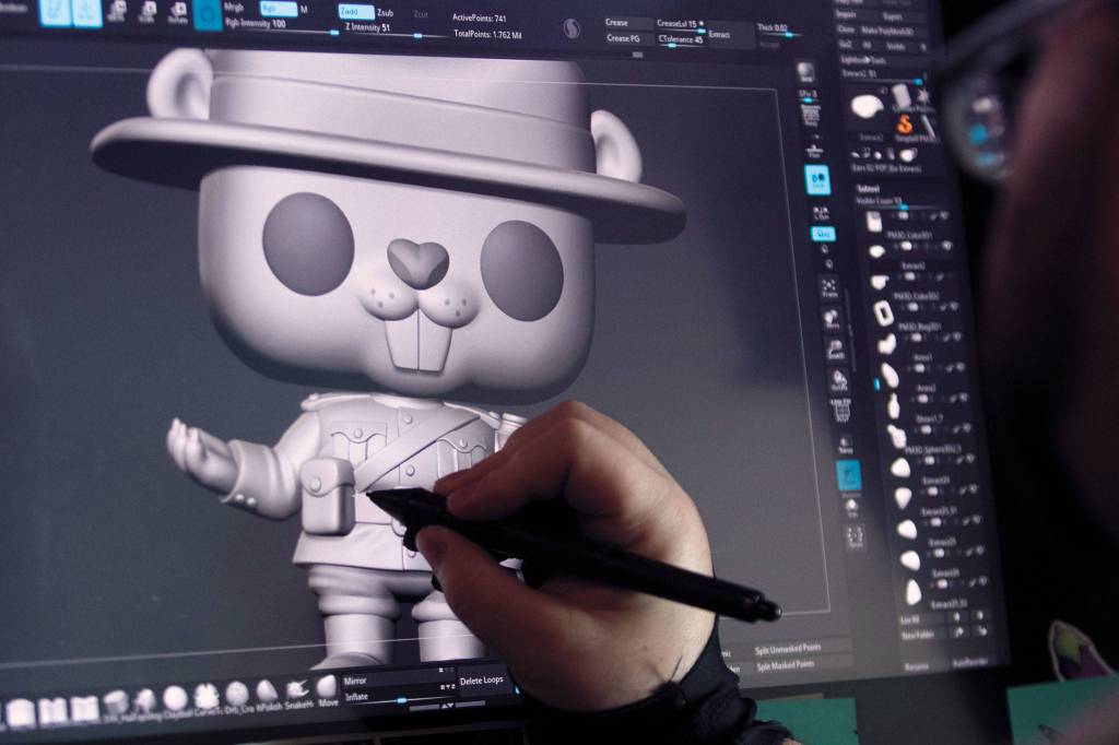 Sculptor Kieran Lampert works on a 3-D rendering of Douglas the Beaver for Funkos Around the World series. (Andy Bronson / The Herald)