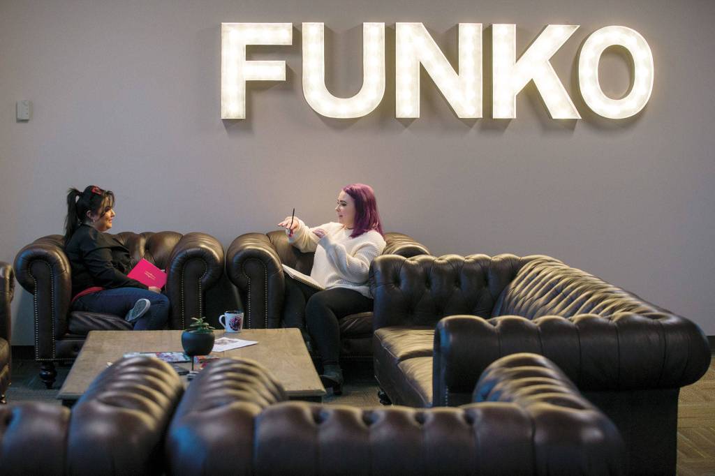 Packaging designers Jessica Nanez and Gwen Machan discuss ideas in the employee cafeteria at Funko headquarters before the coronavirus shutdown. (Andy Bronson / The Herald)