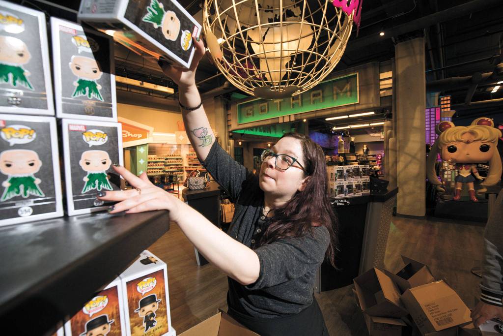 Inventory manager Cassie Smith stocks shelves with the new Marvel 80th First Appearance Vulture Pop! vinyl figure at the Funko store on Wetmore Avenue before the coronavirus shutdown. (Andy Bronson / The Herald)