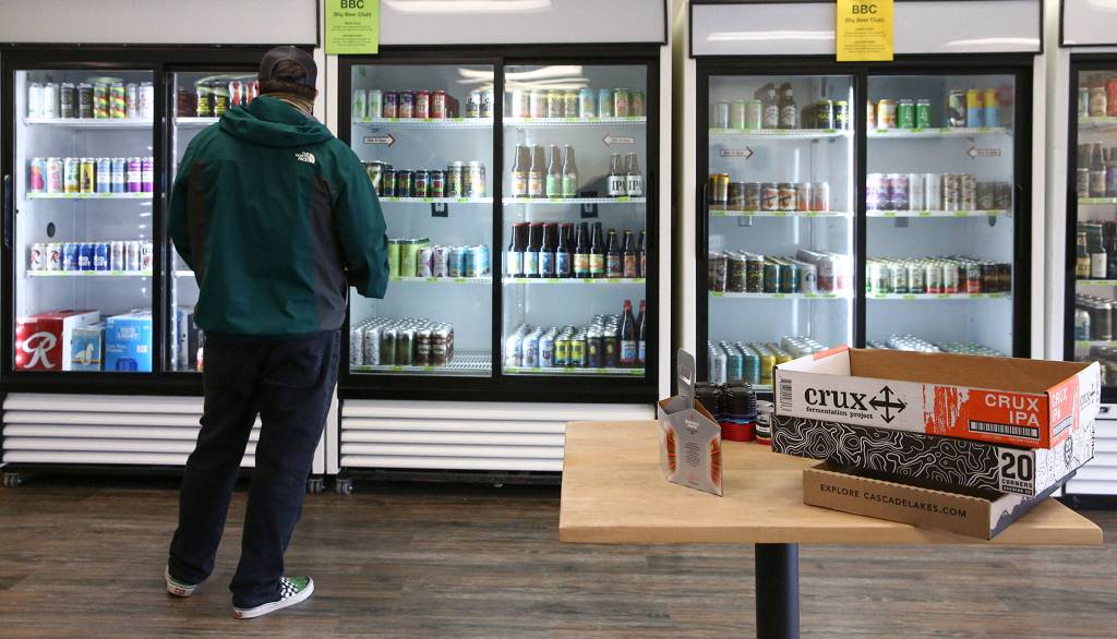 Trip Ramos shops the selection at The Republic Bottleshop in Marysville. The citys first craft beer, cider and seltzer bottle shop opened for business April 24. (Kevin Clark / The Herald)