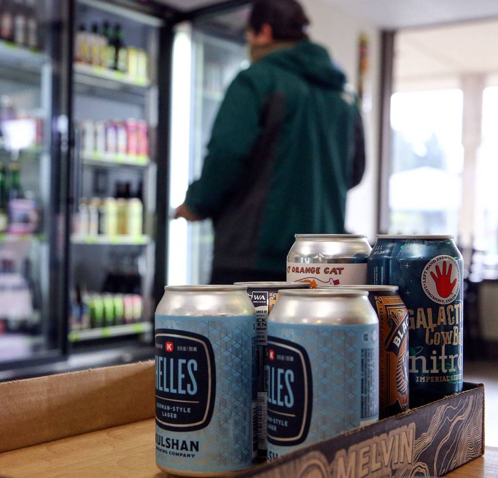 Trip Ramos shops the selection at The Republic Bottleshop in Marysville. (Kevin Clark / The Herald)