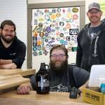 Republic Bottleshop owners Jeff Sadighi (left), TJ Borden (center) and Doug Hall opened for business on April 24. (Kevin Clark / The Herald)