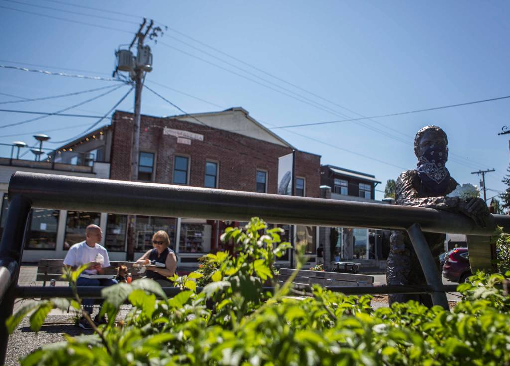 The Boy and Dog statue on First Street in Langley displays a bandana mask. (Olivia Vanni / The Herald)
