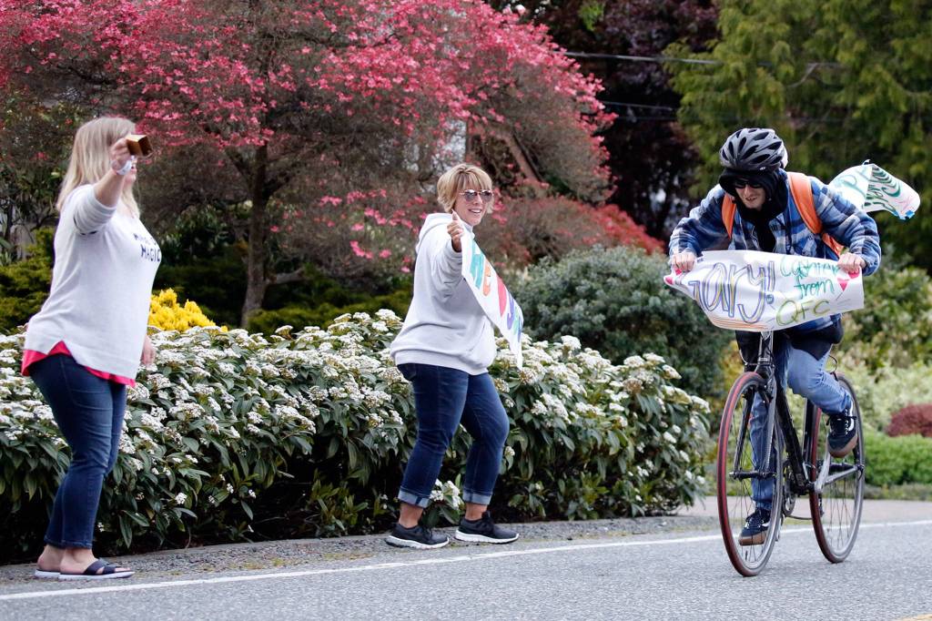 Gary Locke, a QFC worker for 11 years known for his friendly service, is honored as a frontline hero in a nightly parade on 53rd Avenue West in Mukilteo. (Kevin Clark / The Herald)