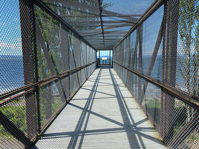 A freaky-yet-scenic pedestrian bridge at crosses over the train tracks to a three-story stairway, all enclosed in chain-link. (Sue Misao / The Herald)