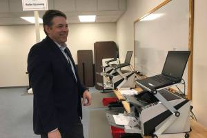 Snohomish County Auditor Garth Fell inspects the testing of ballot-counting equipment prior to the March 10 presidential primary. (Rachel Riley / Herald file photo)