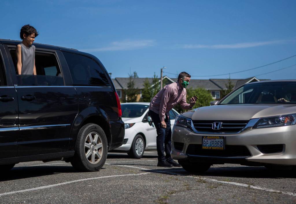 Pastor Aaron Thompson checks in to make sure everyone is connected to the wifi from the parking lot before his service at Marysville Foursquare Gospel Church on Sunday. (Olivia Vanni / The Herald)