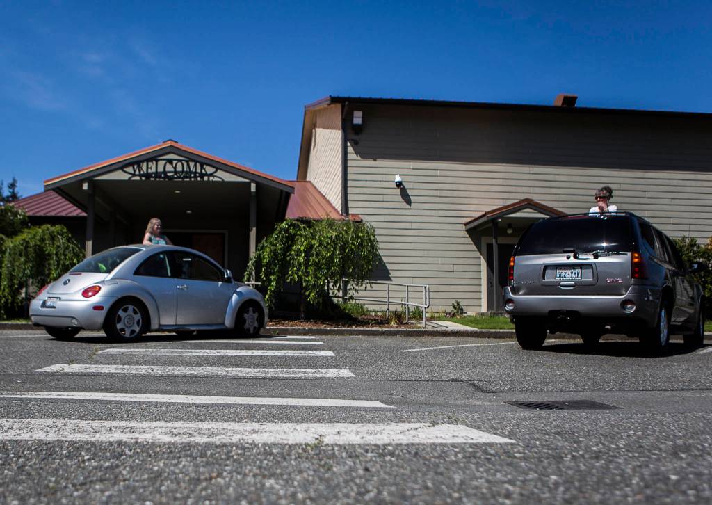 People chat from their cars before the start of the drive-in service at Marysville Foursquare Gospel Church on Sunday, May 10, 2020 in Marysville, Wa. (Olivia Vanni / The Herald)
