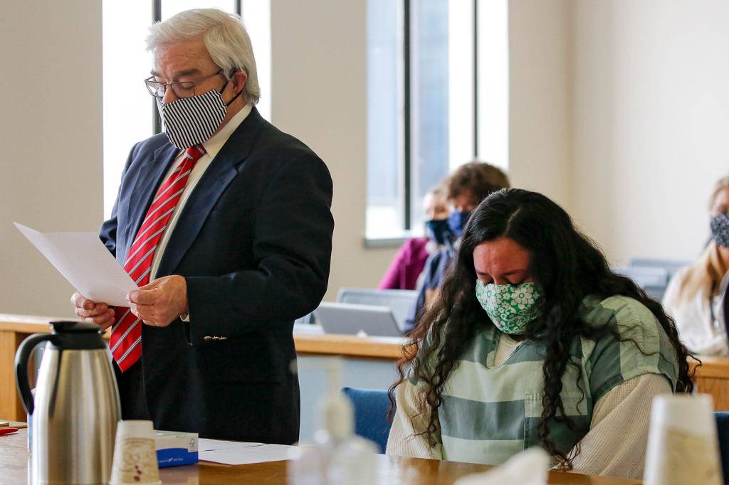 Walter Peale reads Lendsay Mezas statement during her sentencing Thursday afternoon at the Snohomish County Courthouse in Everett. (Kevin Clark / The Herald)