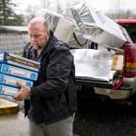 In this March 2014 photo, Gary Ray, then pastor of the Oso Community Chapel, carries chocolate bars as a donation for Oso landslide survivors to serve as comfort food. (Jordan Stead, seattlepi.com file)