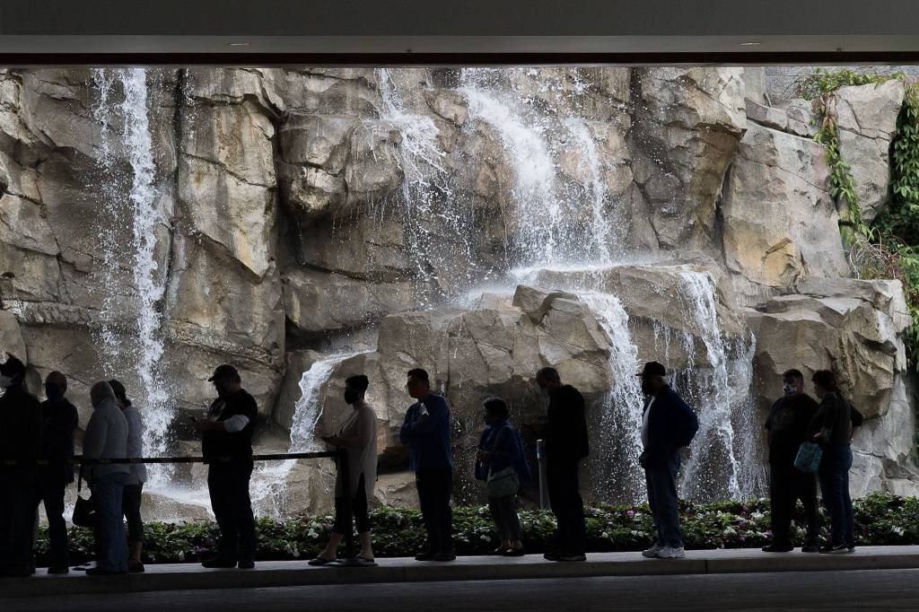 Customers wait in line to enter the Tulalip Resort Casino as it reopens Tuesday. (Andy Bronson / The Herald)