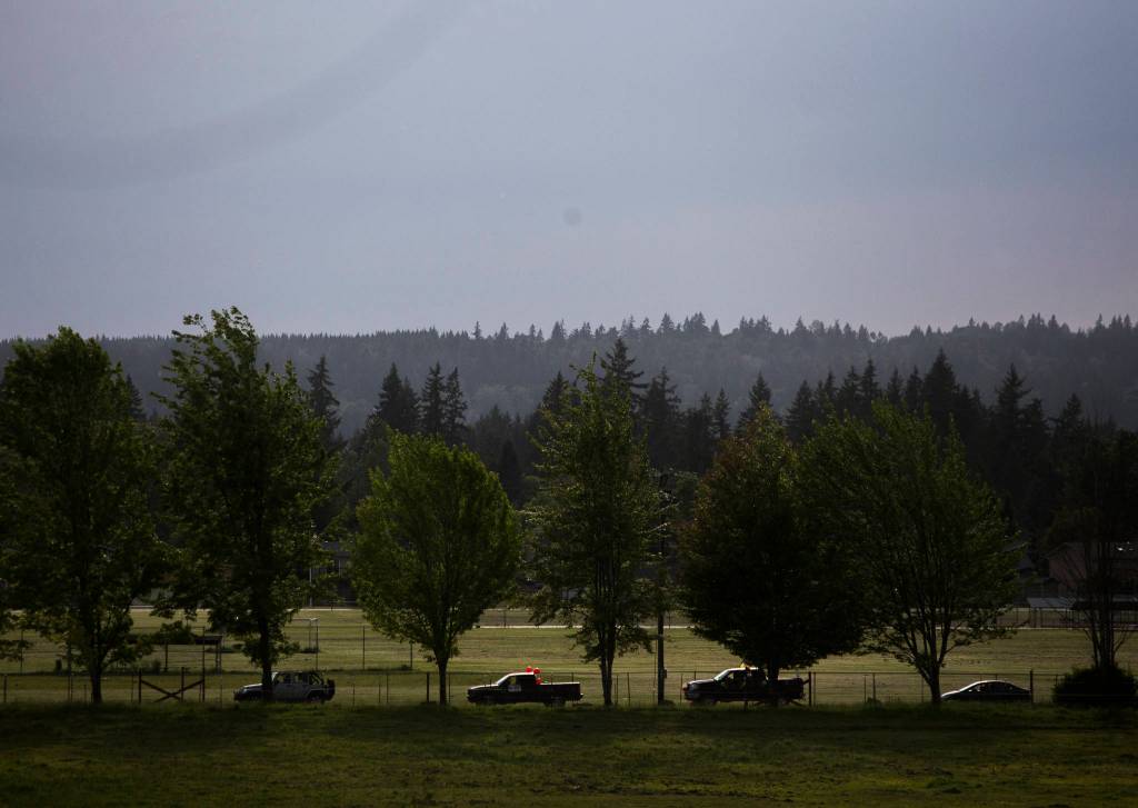 A truck decorated in red balloons waits in a line of cars to join the Marysville-Tulalip All High School Senior Parade on Friday, May 29, 2020 in Marysville, Wa. (Olivia Vanni / The Herald)