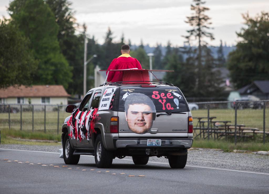 A car is seen with a blown up photo on the back of the car during the Marysville-Tulalip All High School Senior Parade on Friday, May 29, 2020 in Marysville, Wa. (Olivia Vanni / The Herald)