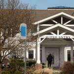 A woman walks up to closed doors at the Josephine Caring Community on March 11 in Stanwood. (Andy Bronson / Herald file)