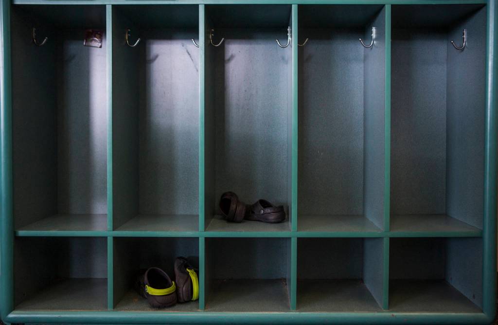 Shoes sit in a row of empty cubbies at the Starbright Early Learning Center in Everett. (Olivia Vanni / The Herald)