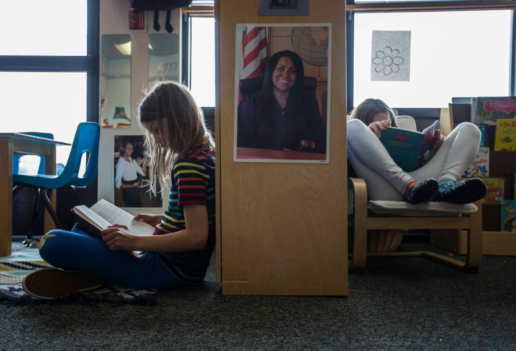 Inara Attick (left) and Indiana Smasne read books at Starbright Early Learning Center in Everett. (Olivia Vanni / The Herald)