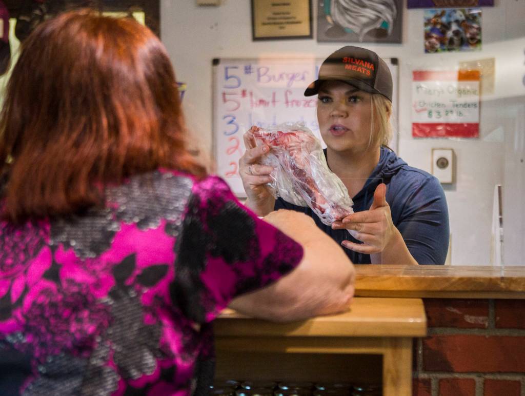 Sarah Floe helps a customer pick a cut of meat on Friday, May 29, 2020 in Silvana, Wa. (Olivia Vanni / The Herald)