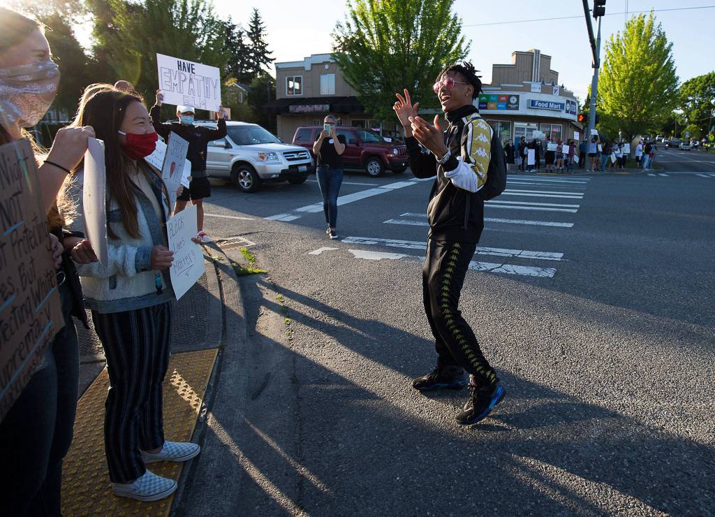 Justice Jackson, of Marysville, thanks supporters as they protest at corners of 2nd and D St in Snohomish on Monday. (Andy Bronson / The Herald)
