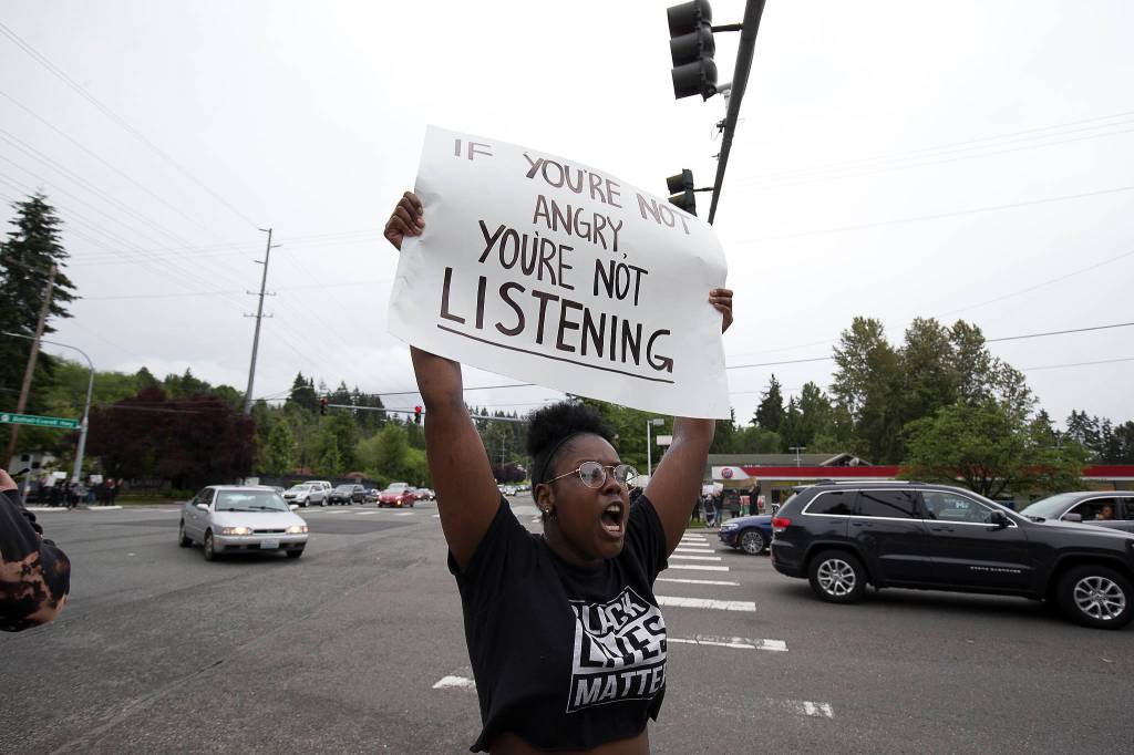 Olivia Craven cheers on about two hundred protesters at the intersection of 164th Street and the Bothell-Everett Highway, to protest the killing of George Floyd, on Tuesday, June 2, 2020 in Mill Creek, Wa. (Andy Bronson / The Herald)