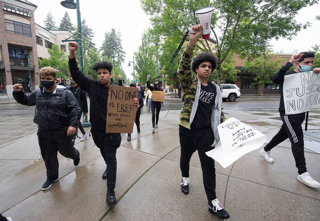 Silent with raised fists, protester march silently for eight minutes and 49 seconds, to protest the killing of George Floyd, on Tuesday, June 2, 2020 in Mill Creek, Wa. (Andy Bronson / The Herald)