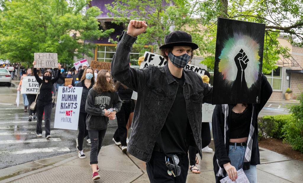 About two hundred protesters marched though Mill Creek, to protest the killing of George Floyd, on Tuesday, June 2, 2020 in Mill Creek, Wa. (Andy Bronson / The Herald)