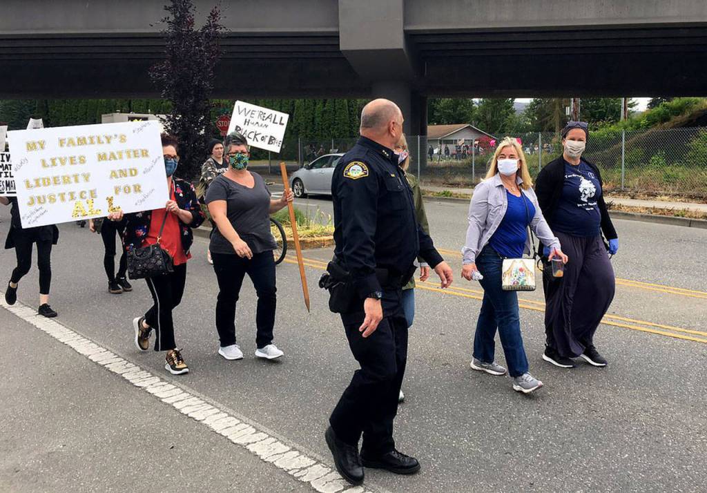 Monroe Police Chief Jeffrey Jolley thanks the people who are walking in the Justice March for George Floyd in Monroe on Wednesday. (Nick Patterson / The Herald)