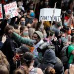 Activist David Lewis (center) walks through a crowd of protesters as he heads into Seattle City Hall to meet with the mayor Wednesday in Seattle, following protests over the death of George Floyd, a black man who was in police custody in Minneapolis. (AP Photo/Elaine Thompson)