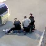 This frame from a video shows a Snohomish County sheriffs deputy punching a man who is lying on the ground and apparently not resisting.