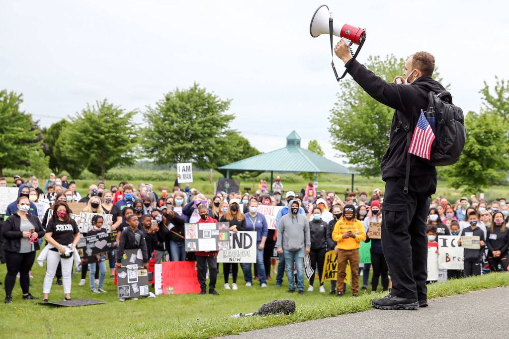 Former Monroe football player Isaiah Cole leads the Justice March for George Floyd in Monroe this past Thursday morning. (Kevin Clark / The Herald)