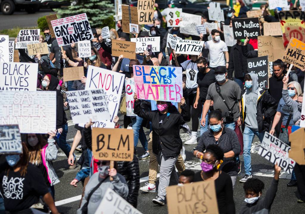 Hundreds of protesters walk down Everett Avenue on Saturday, June 6, 2020 in Everett, Wa. (Olivia Vanni / The Herald)