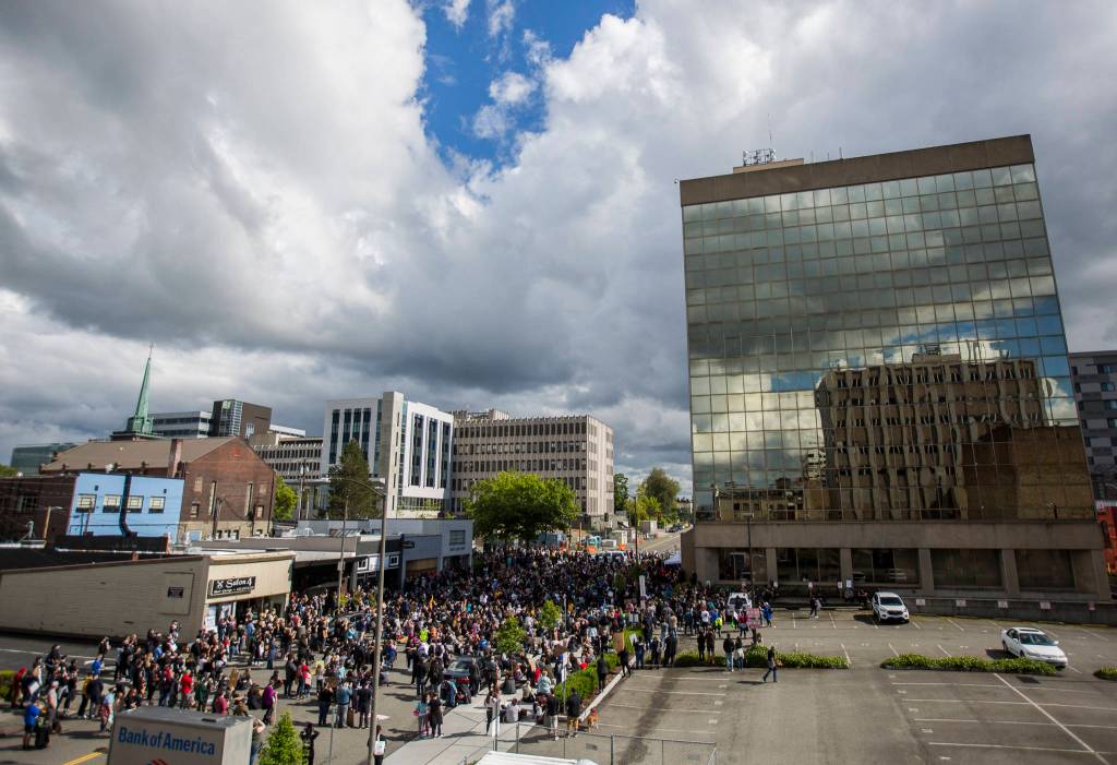 Protesters gather at the Everett Municipal Building on Saturday. (Olivia Vanni / The Herald)