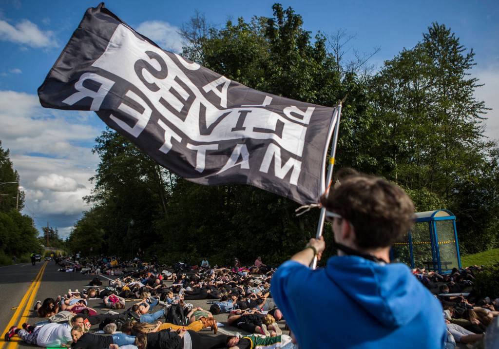 Protesters lay in the southbound lanes of Mukilteo Speedway for 8 minutes and 46 seconds, the amount of time George Floyd had a knee on his neck, during the Black Lives Matter protest on Sunday in Mukilteo. (Olivia Vanni / The Herald)