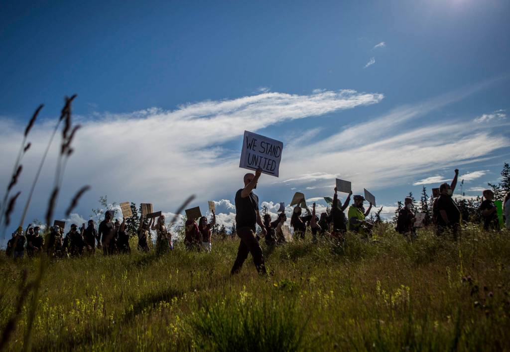 Protesters walk along Mukilteo Speedway during the Black Lives Matter protest on Sunday in Mukilteo. (Olivia Vanni / The Herald)