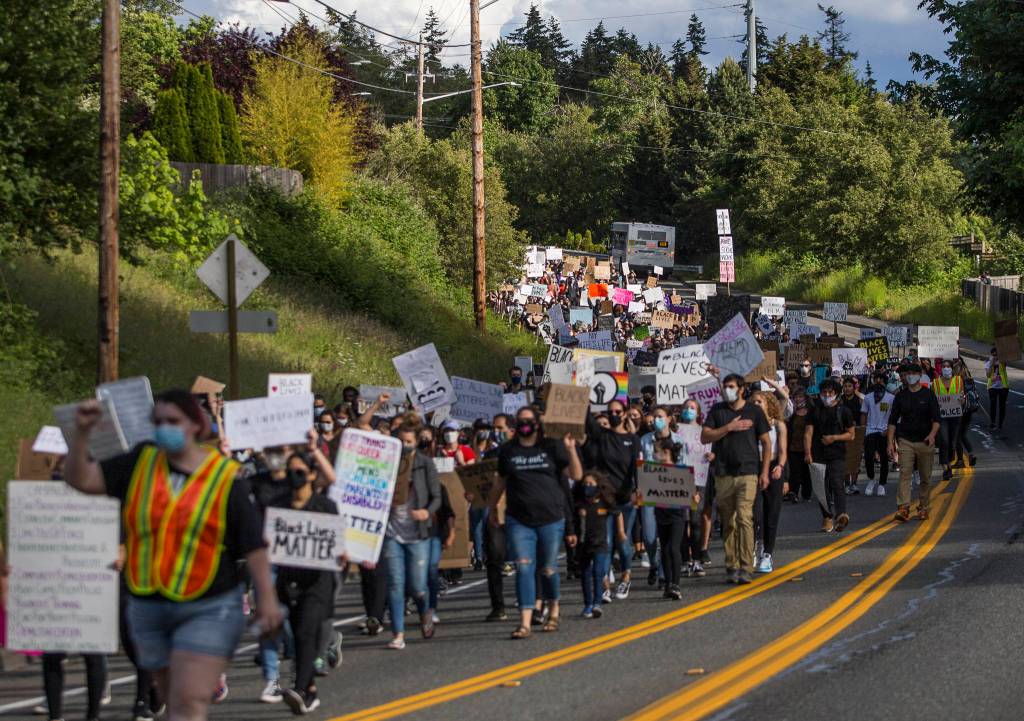 Hundreds of protesters round a corner along Mukilteo Speedway during the Black Lives Matter protest on Sunday in Mukilteo. (Olivia Vanni / The Herald)