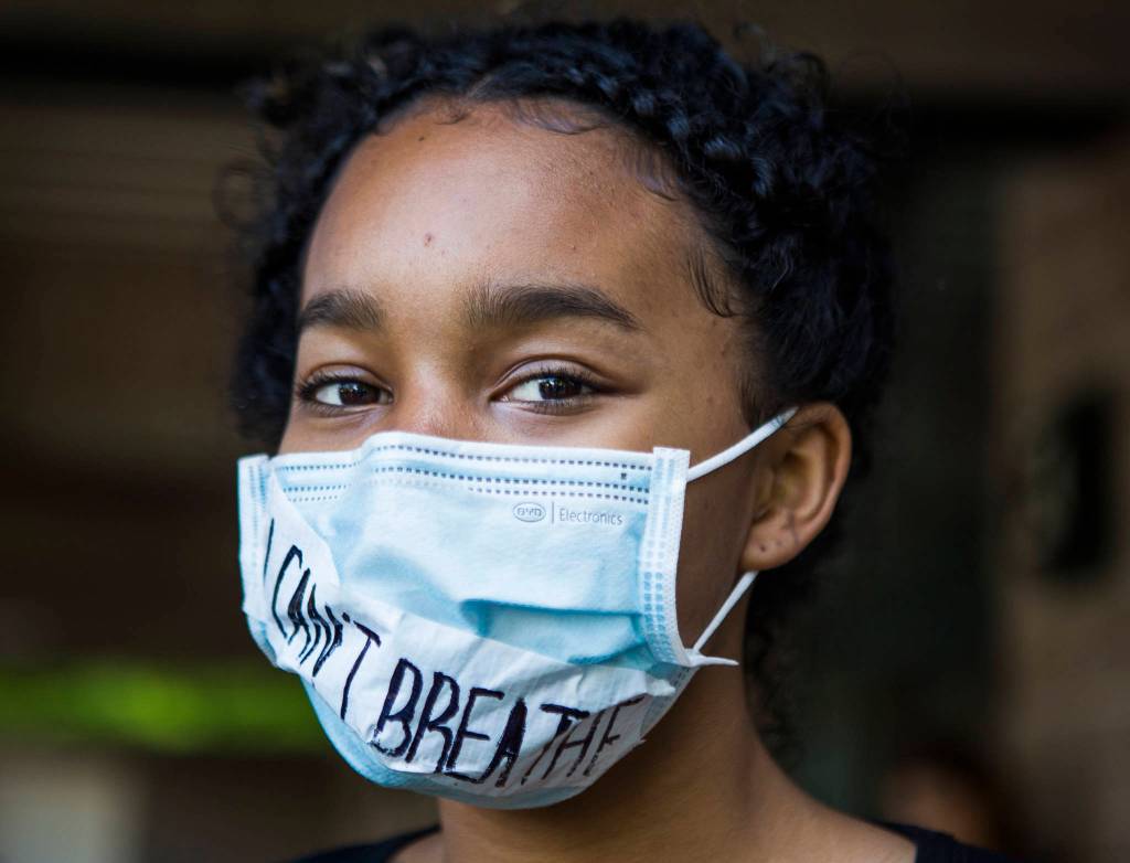 Orlaan Winston wears a mask with the phrase I Cant Breathe across it during the Black Lives Matter protest on Sunday in Mukilteo. (Olivia Vanni / The Herald)