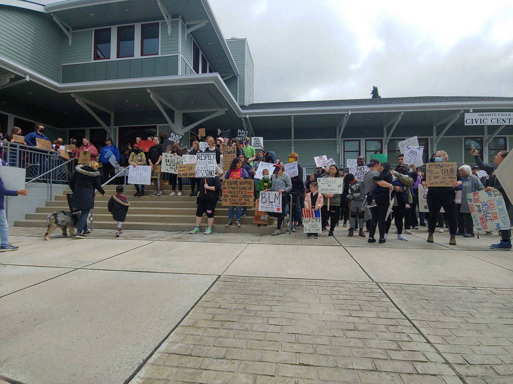 Black Lives Matter protestsrs stand on the steps of Granite Falls City Hall on Sunday. (Zac Hereth / The Herald)