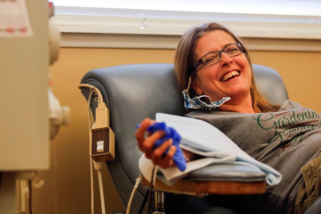 Paula Perez donates COVID-19 antibody-rich plasma Thursday afternoon at PlasmaLab International in Everett. (Kevin Clark / The Herald)