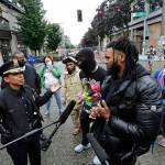 Seattle Police Chief Carmen Best (left) talks with activist Raz Simone (right front) and others near a plywood-covered and closed Seattle police precinct behind them Tuesday in Seattle, following protests over the death of George Floyd. (AP Photo/Elaine Thompson)