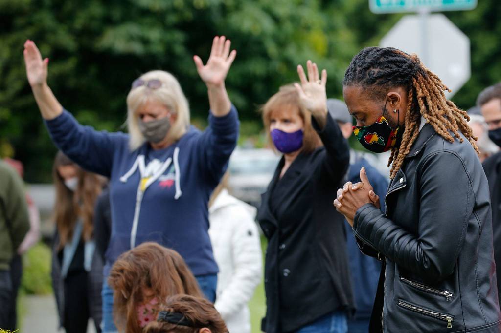 Pastor Jermell Witherspoon, far right, prays during the community prayer vigil at Jubilee Church of God in Christ in Everett on Friday afternoon June 12, 2020. (Kevin Clark / The Herald)