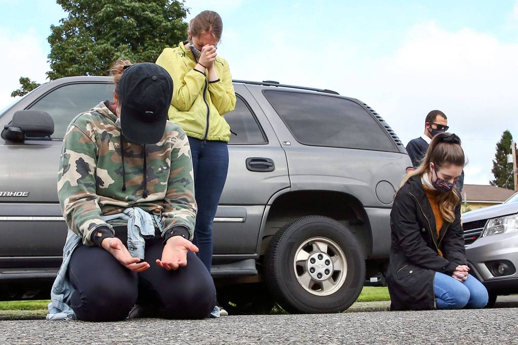 Residents pray during the community prayer vigil at Jubilee Church of God in Christ in Everett on Friday afternoon June 12, 2020. (Kevin Clark / The Herald)