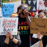 Young people hold signs and chant as they march through the core of Marysville Thursday afternoon. (Kevin Clark / The Herald)