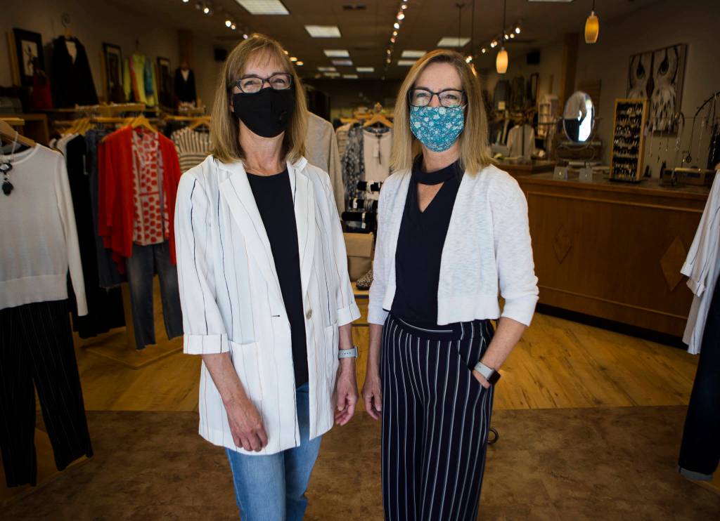 Sharon Stanford and Sue Nemo at their shop, Renees Contemporary Clothing in Everett, on Friday. (Olivia Vanni / The Herald)