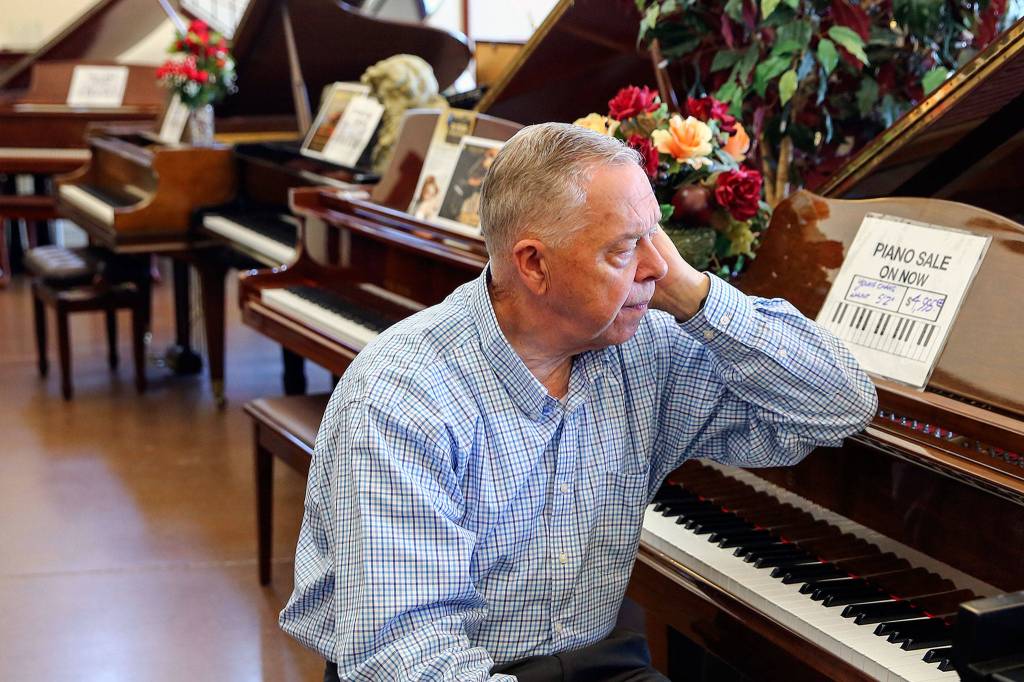 John Pedigo, owner of Pedigo Pianos in Everett, saw sales drop during the shutdown and has decided to retire. (Kevin Clark / The Herald)